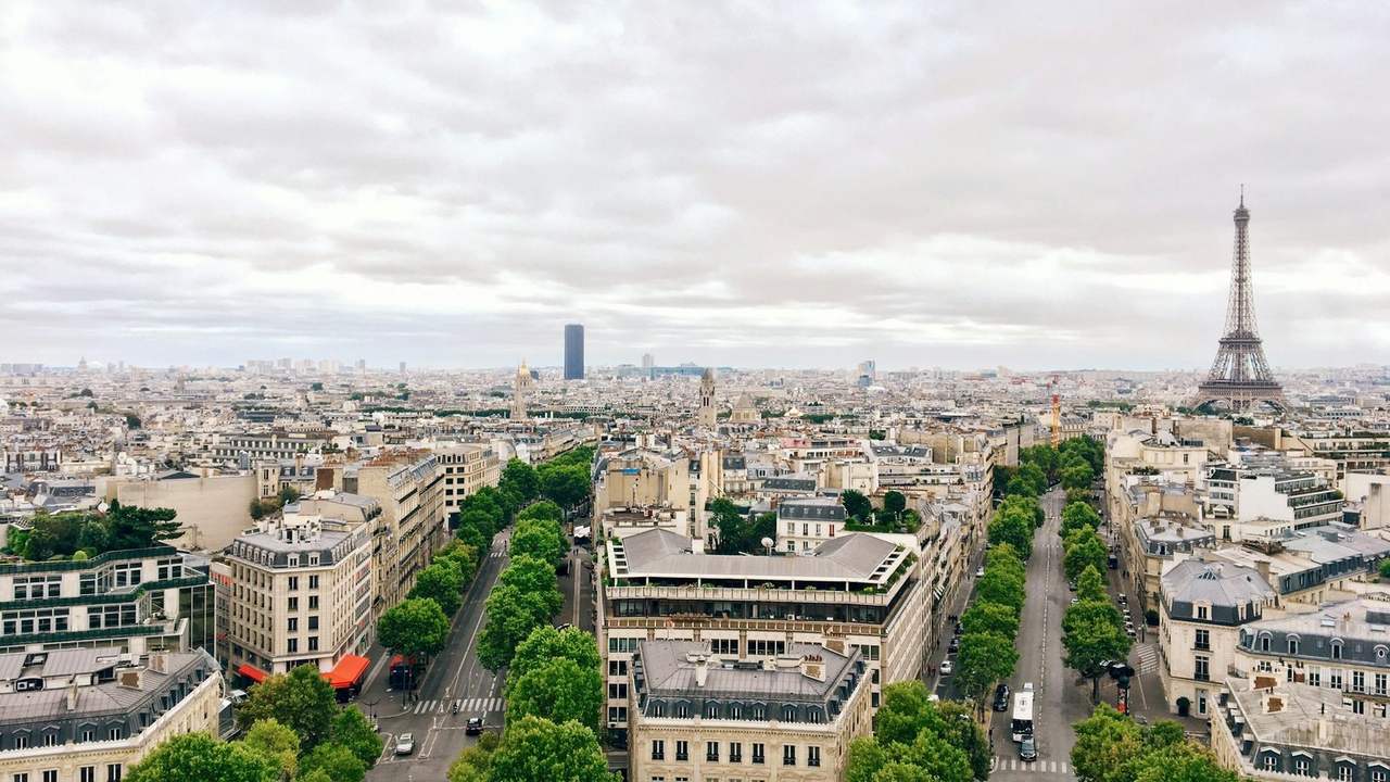 Paris văzut de la Arcul de Triumf, cu Turnul Eiffel în dreapta și acoperișurile orașului